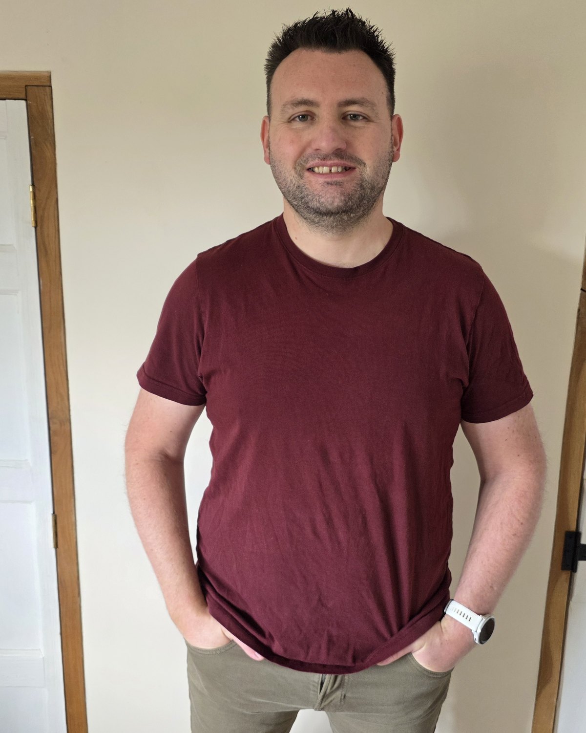 Terry McCall standing between two doorframes, hands in pockets